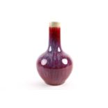 A Chinese flambe bottle vase, the red body with lavender streaks, 23.5cmCondition report: No obvious