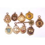 A group of ten various early 20th century 9ct rose and yellow gold sporting award medallion