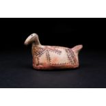 A Pre Colombian pottery zoomorphic figure, with avian like qualities, hand painted with geometric