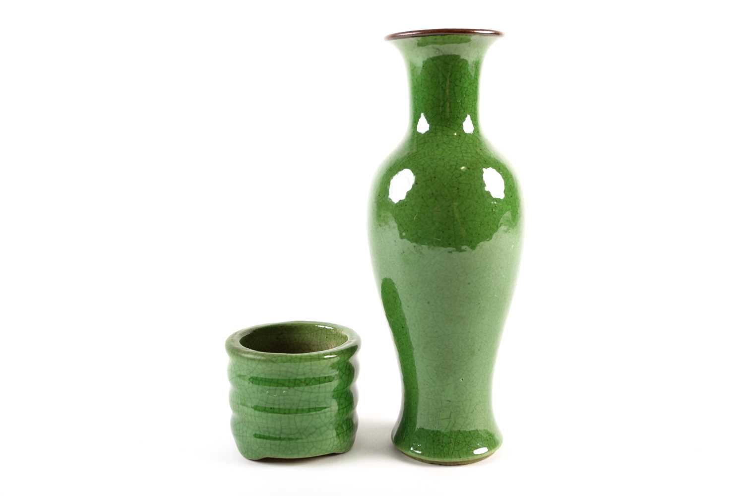 A Chinese green glazed vase, of slender baluster form, with a brown rim, the glaze with fine
