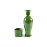 A Chinese green glazed vase, of slender baluster form, with a brown rim, the glaze with fine