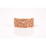 An 18ct rose gold and diamond half-hoop band ring, pave-set with round brilliant-cut diamonds of