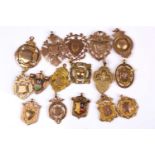 A group of sixteen various late 19th / early 20th century 9ct rose and yellow gold medallion