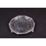 A Victorian silver salver, London, 1897 by Moss Morris, with piecrust edge on three pieced feet.