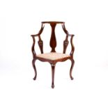 An Edwardian mahogany and boxwood strung corner armchair, with central vase shape splat flanked by