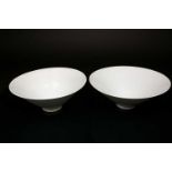A near pair of Chinese qingbai style bowls, 20th century, of conical form, the interiors with