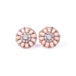 A pair of coral and diamond cluster earrings, the flowerhead plaques set with a central old rose cut