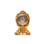 A 19th century gilt metal desk clock, in the roccoco style, with adapted pocket watch movement, 10