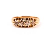 An 18ct yellow gold and brown diamond ring, set with four small old-cut diamonds, the shank marked