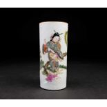 A Chinese cylindrical brush pot, painted with a well dressed lady in a garden with plum blossom,