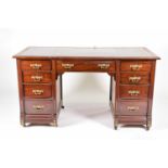 A Victorian mahogany veneered aesthetic desk, circa 1880, with green tooled leather writing