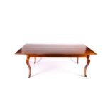 A large French cherrywood dining table, the rectangular top with cleated ends, supported on french
