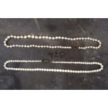 A graduated cultured pearl necklace with base metal clasp, together with another similar, and a