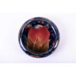 A Walter Moorcroft pin dish in the Pomegranate pattern on a deep blue ground, painted and