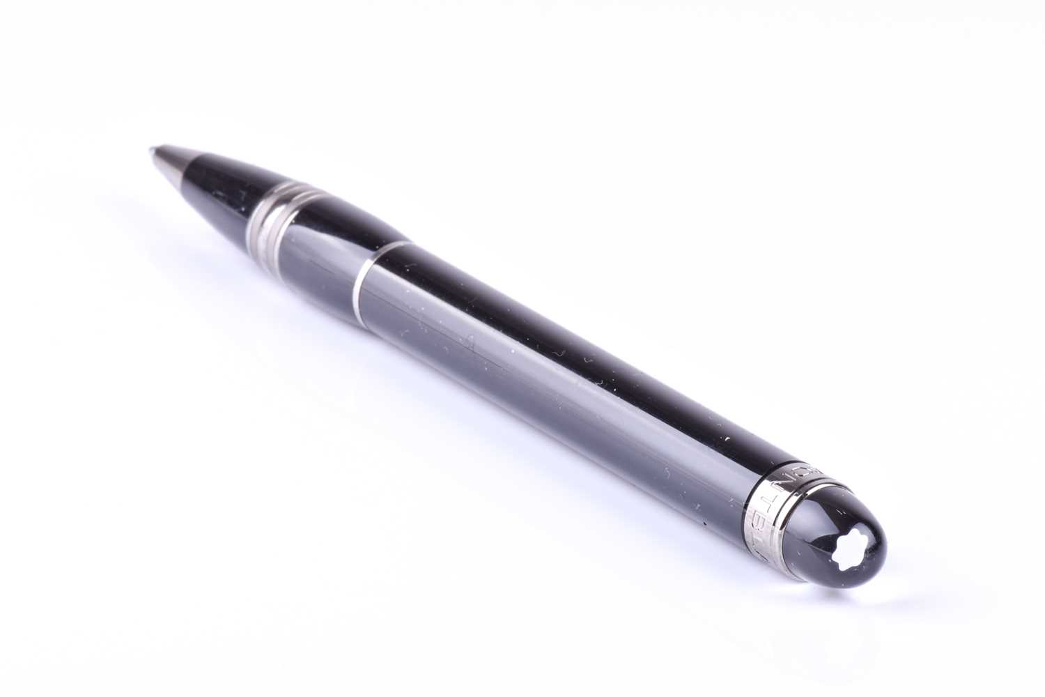 A Montblanc ballpoint pen, with black resin body and black polished metal mounts, with clear rein