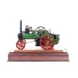 A fine quality scratch built scale model of a coal powered traction engine, in a wood and glass