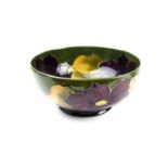 A mid 20th century Moorcroft bowl, decorated with clematis flowers in purple, pink, and pale green