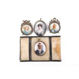 A pair of late 19th century portrait miniatures on ivory, depicting a gentleman and a lady, one in a