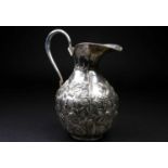 A large Spanish silver ewer, mid 20th century, embossed with fruiting vines, 477 grams, 26.5cm