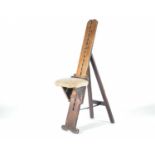 A 19th century en-plein air artists chair, with adjustable seat and folding easel support, the