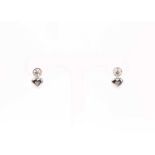 A pair of diamond heart-shaped drop earrings, each heart inset with three small diamonds,