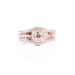 A silver and diamond dress ring, set with a light brown diamond of approximately 0.25 carats, within