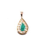 A yellow metal, diamond, and emerald pendant, set with a mixed pear-cut emerald within a border of