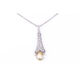 A Belle Epoque yellow sapphire and diamond pendant, the pear cut natural yellow diamond in rub