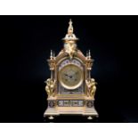 A French gilt metal and champleve enamel mantel clock, with eight day movement chiming on a bell,