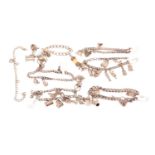 A group of six various silver charm bracelets, hung with a variety of different charms including