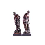 A near pair of late 19th century patinated bronze figural studies of female bathers, semi clad and