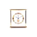 A Jaeger-Le Coultre brass mantel or desk clock, of square form with suspended circular chapter