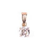 A single stone diamond pendant, the round brilliant cut diamond in simple four claw mount, the