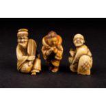 Three Japanese ivory netsukes, Meiji/Taisho period, comprising a doll maker with Daruma doll,