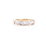 A yellow metal and diamond band ring, channel-set with six round brilliant-cut diamonds of