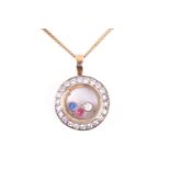 A yellow metal and paste gemstone pendant, in the 'Floating Diamond' style, set with red and blue