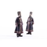 A pair of Russian Faberge style cold painted bronze Cossacks, each in winter uniform, inscribed in