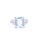 An aquamarine and diamond ring, set with an emerald-cut aquamarine, measuring approximately 9 x 11