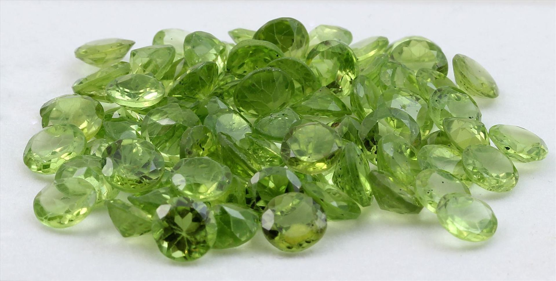 Ca. 70 Peridote, zus. ca. 55,5 ct.Rund facettiert mit natürlichen Merkmalen.