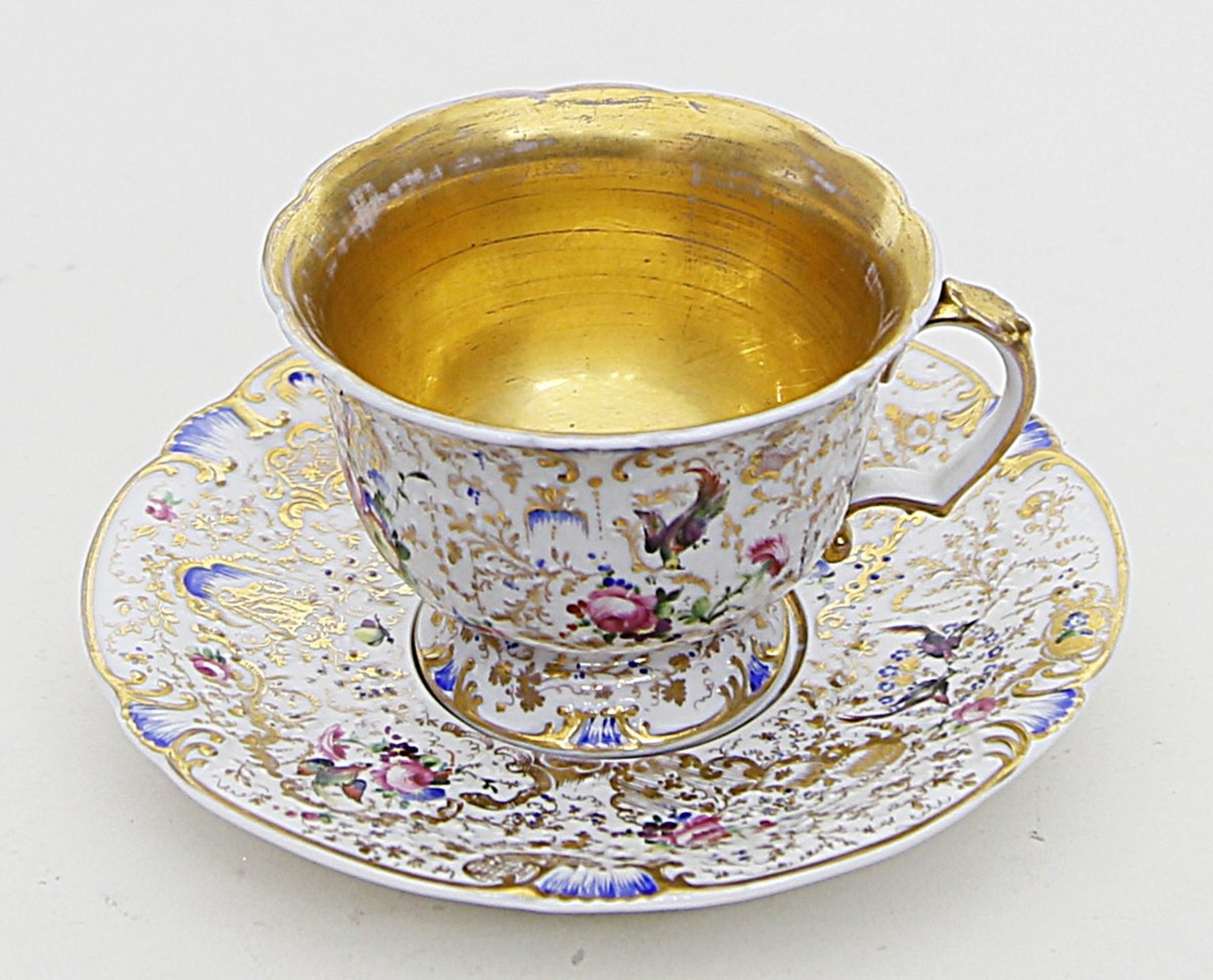 Ziertasse mit Untertasse, KPM Berlin.Teils Rocaillenrelief. Umlaufend reiche Gold- und bunte