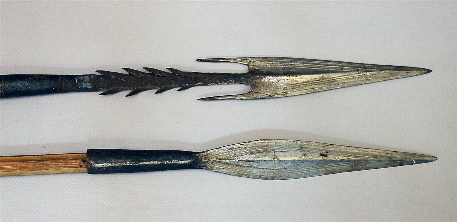 2 afrikanische Speere.Eisenklingen. Holzschäfte. L. 140 bzw. 149 cm.