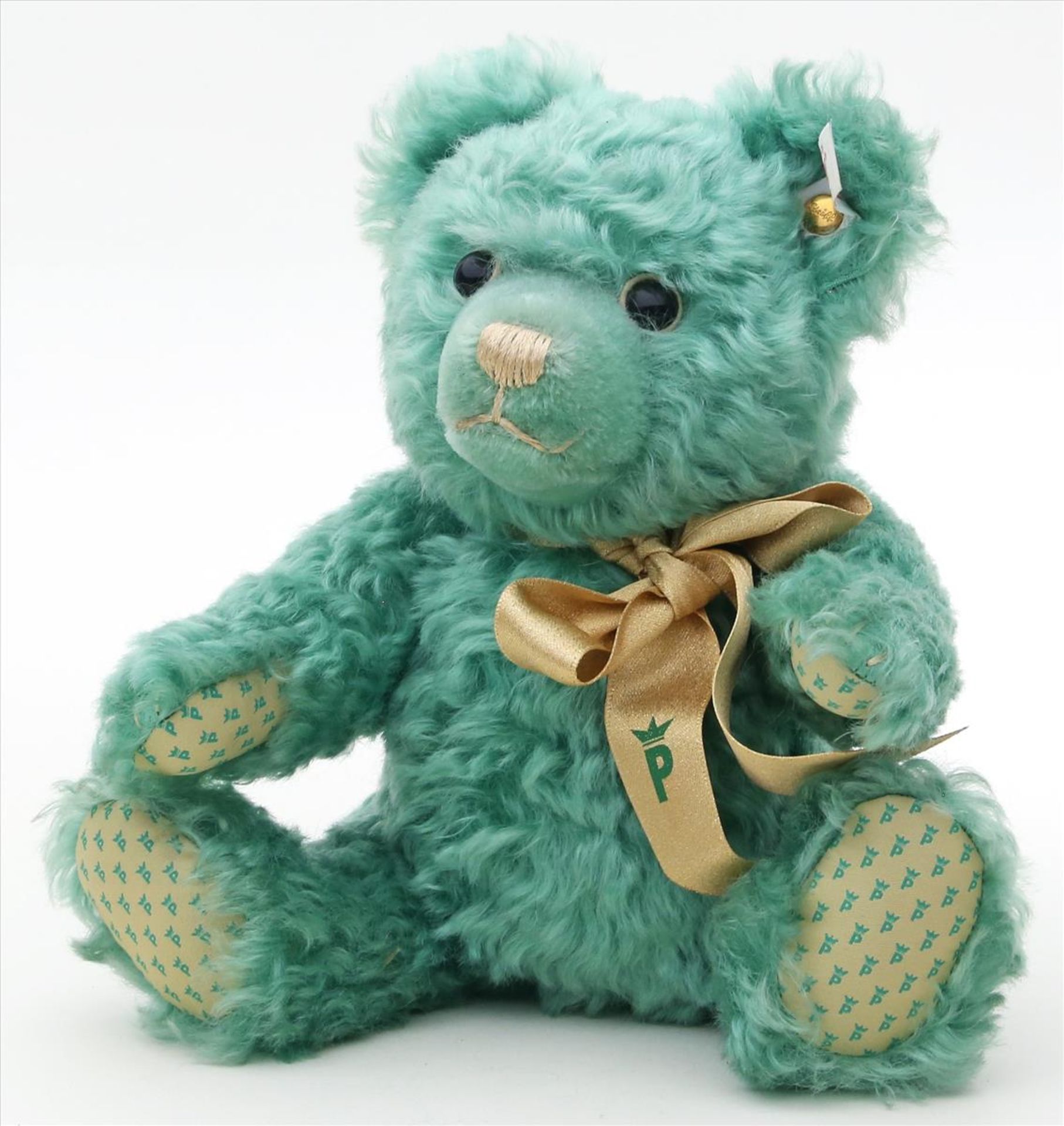 Teddy "Palmers", Steiff.Grüner Mohair. K und F. Hergestellt für die Firma Plamers. H. 25 cm.