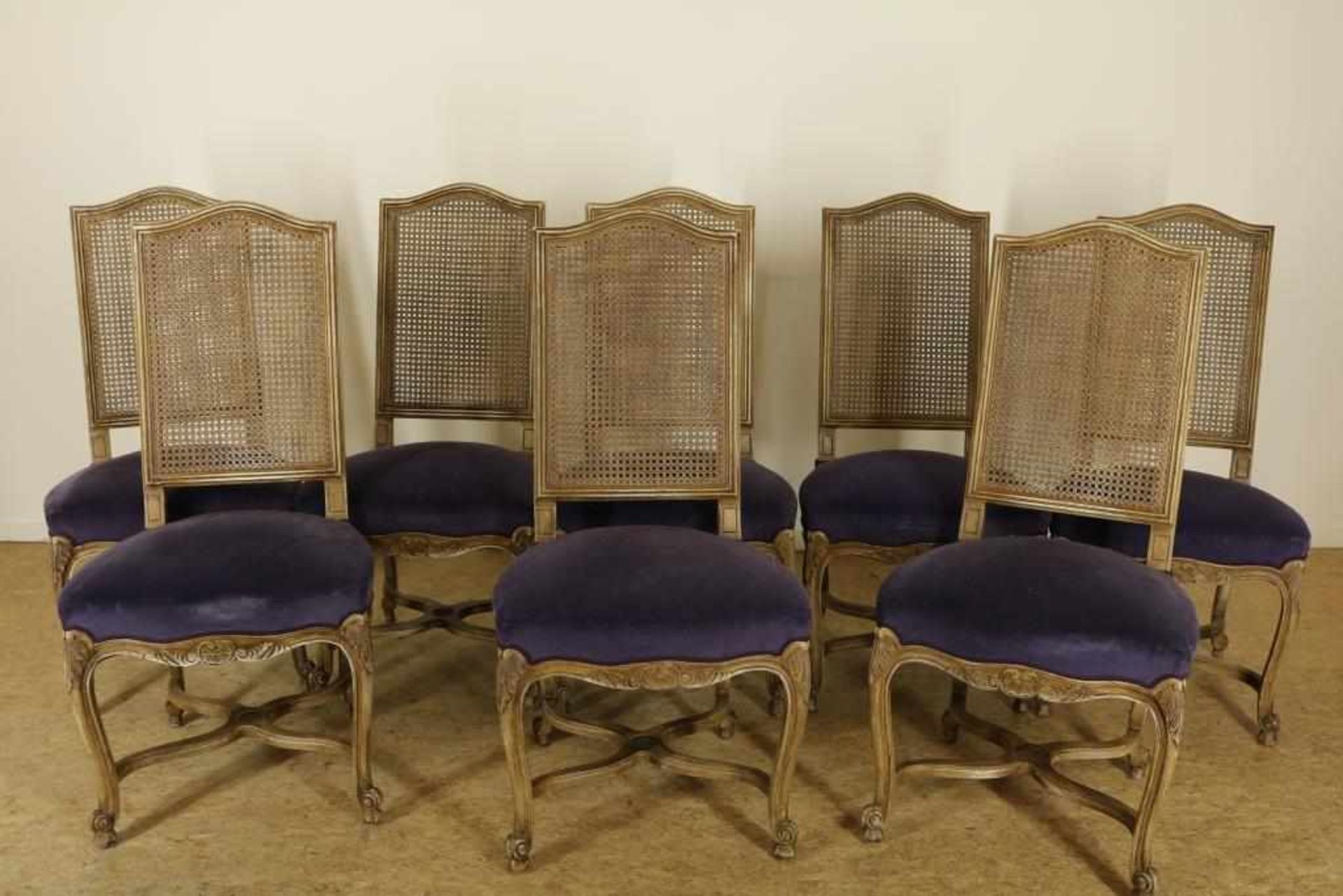 A set of 8 white wash Louis XVI-style chairs with purple velvet lining