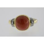 A yellow gold and platinum ring with precious coral and brilliant cut diamonds, total 0.20ct, 750/