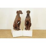 Set terracotta sculptures in the form of sitting greyhounds h.82 cm, on movable wooden consoles,Stel