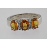 A white gold ring mounted with orange sapphire 2.12ct. and brilliants 0.13ct. 18ct. w. 6.3gr. size