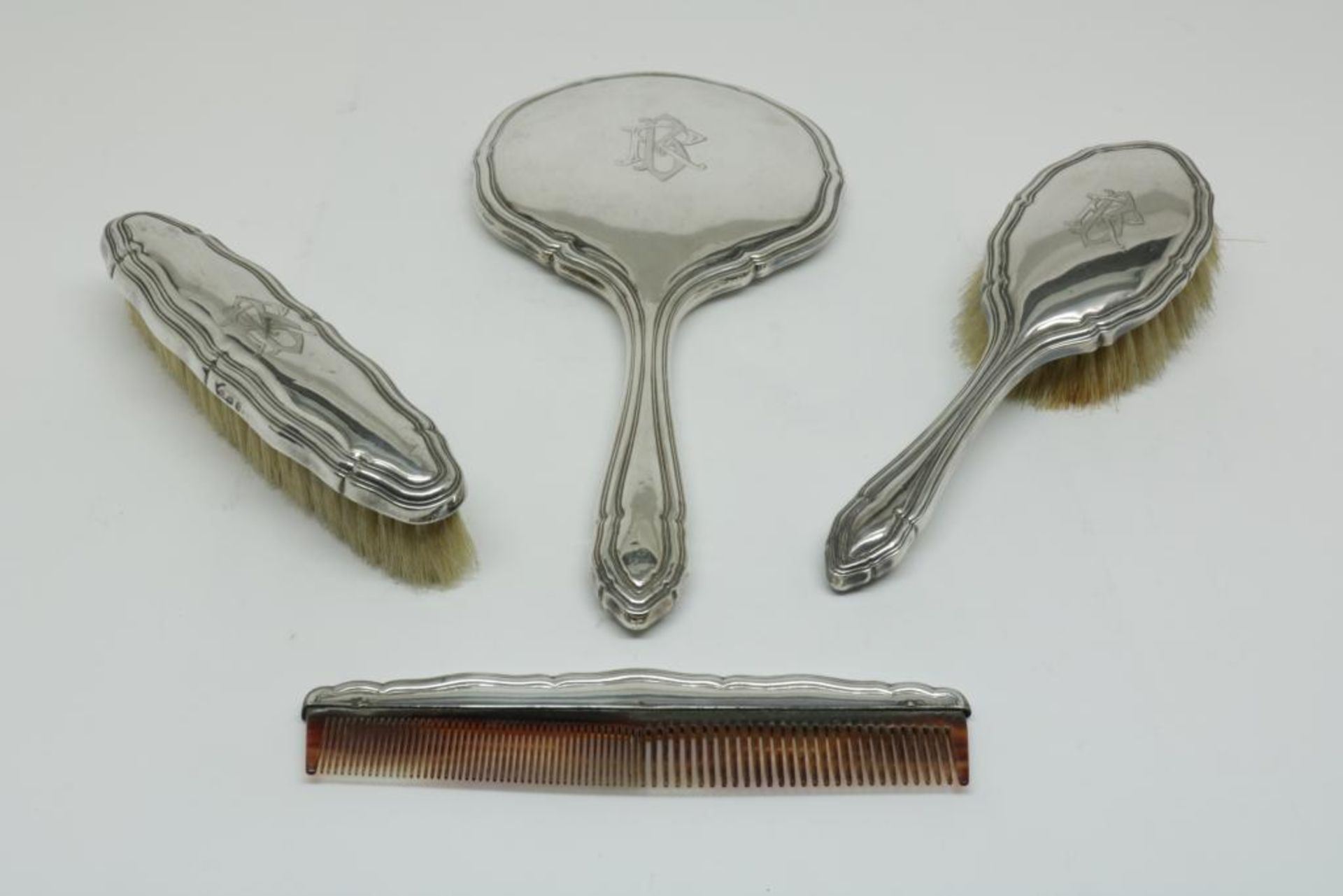 A silver fanity set, German, 800/000, gross w. 623gr, monogrammed.Een vierdelig zilveren kapset,