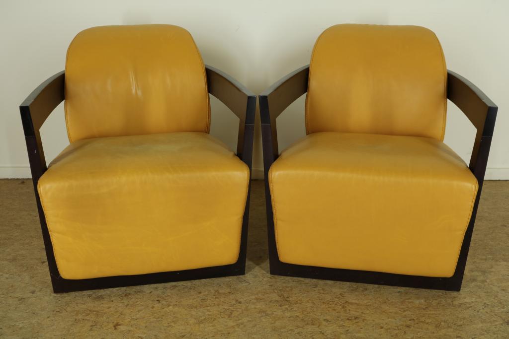 Set design chairs with ocher yellow leather upholstery and wooden armrests, Calia Italy label.Stel