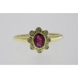 A yellow gold cluster ring set with ruby and diamonds, total 0.15ct, 585/000, gross w. 3.2gr,