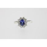A white gold dress ring mounted with sapphire, ca. 1.10ct and brilliant cut diamonds, total ca. 0.